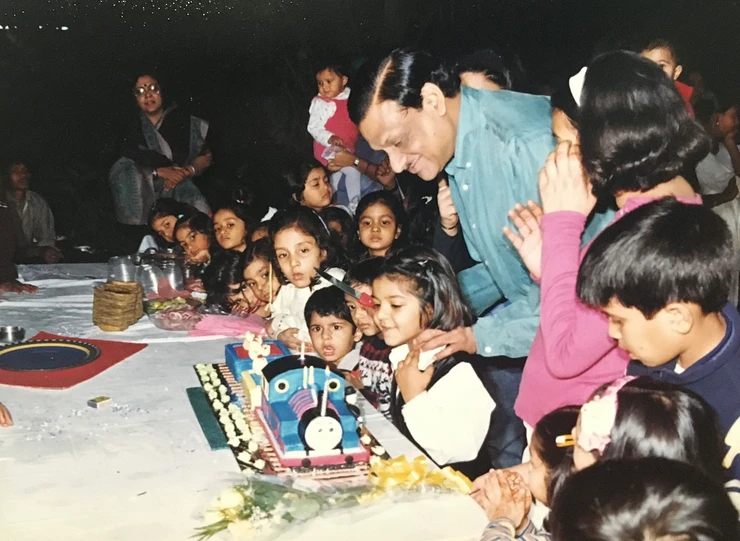 Shivi cutting a birthday cake with her Bada Dadu