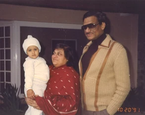 Ajay Rungta (Dadu) and his wife (Ma) with their grandchild Popo. Ma holds Popo. Dated October 20, 1991.