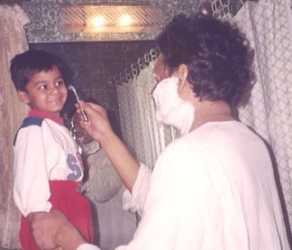 Ajay 'Dadu' Rungta, with shaving cream on his face, lovingly interacts with his young grandson Aman, holding a razor.