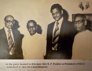 Sepia photo of Ajay Rungta (Dadu) with Shri B.P. Poddar (FICCI President) and Ex-Chief Minister P.C. Sen at a felicitation party.