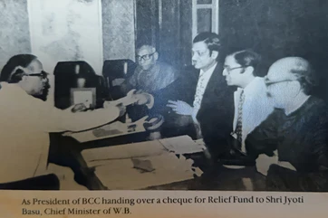 B&W photo: Ajay Rungta (BCC President) presents relief fund cheque to West Bengal CM Jyoti Basu, with others present.