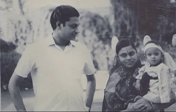 Vintage photo: Ajay Rungta (Dadu) stands beside his wife (Ma), who is holding a young child. A glimpse into their early family life.