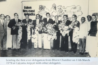 Black and white photo: Ajay Rungta and Bharat Chamber delegates holding flower garlands at Calcutta Airport, March 1978.