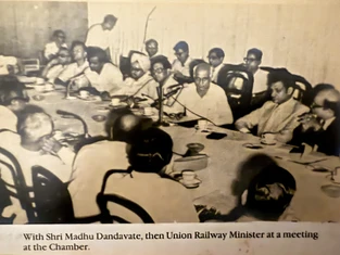 Sepia photo: Ajay Rungta (Dadu) at a Chamber meeting with Union Railway Minister Madhu Dandavate and colleagues around a table.