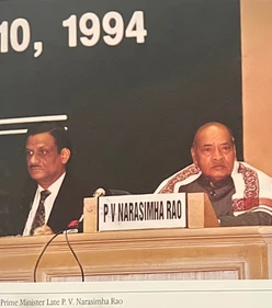 Formal photograph of Ajay Rungta (Dadu) and Prime Minister P. V. Narasimha Rao seated at an event, with the date '10, 1994' visible.