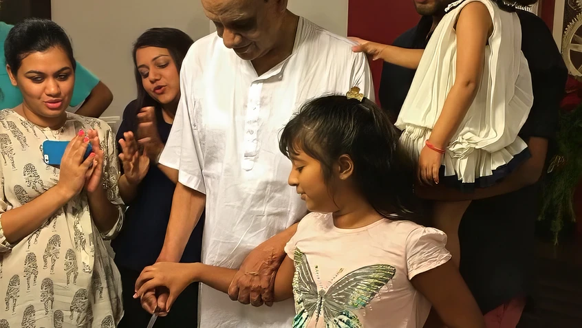 Dadu Cuts Cake with Granddaughter