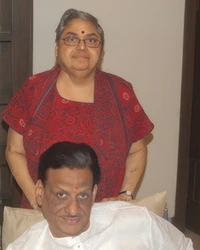 Ajay Rungta (Dadu) seated, with Ma standing behind him, both smiling. Photo taken during Diwali 2010.
