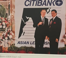 Ajay Rungta (Dadu) and U.S. President George H. Bush standing together, smiling, at a formal Citibank Asian Leadership event.