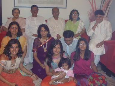 Large family group photo taken indoors during Diwali. Ajay Rungta (Dadu) is surrounded by family members of various ages.